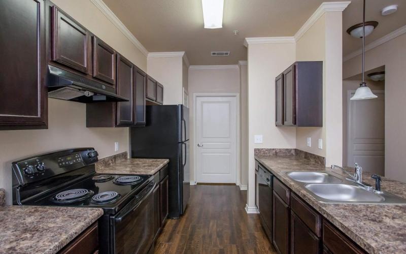 a kitchen with a black refrigerator
